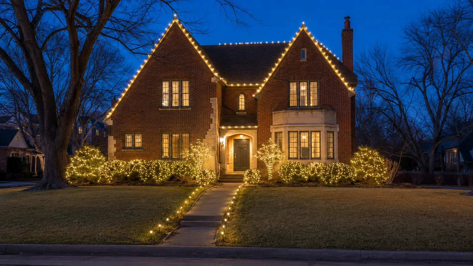 Warm Christmas lights on roofline, pathways and landscaping